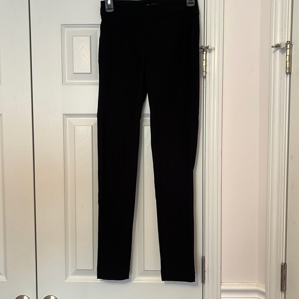 Rayon/Nylon/Spandex slip on dress pants. Skinny at bottom.